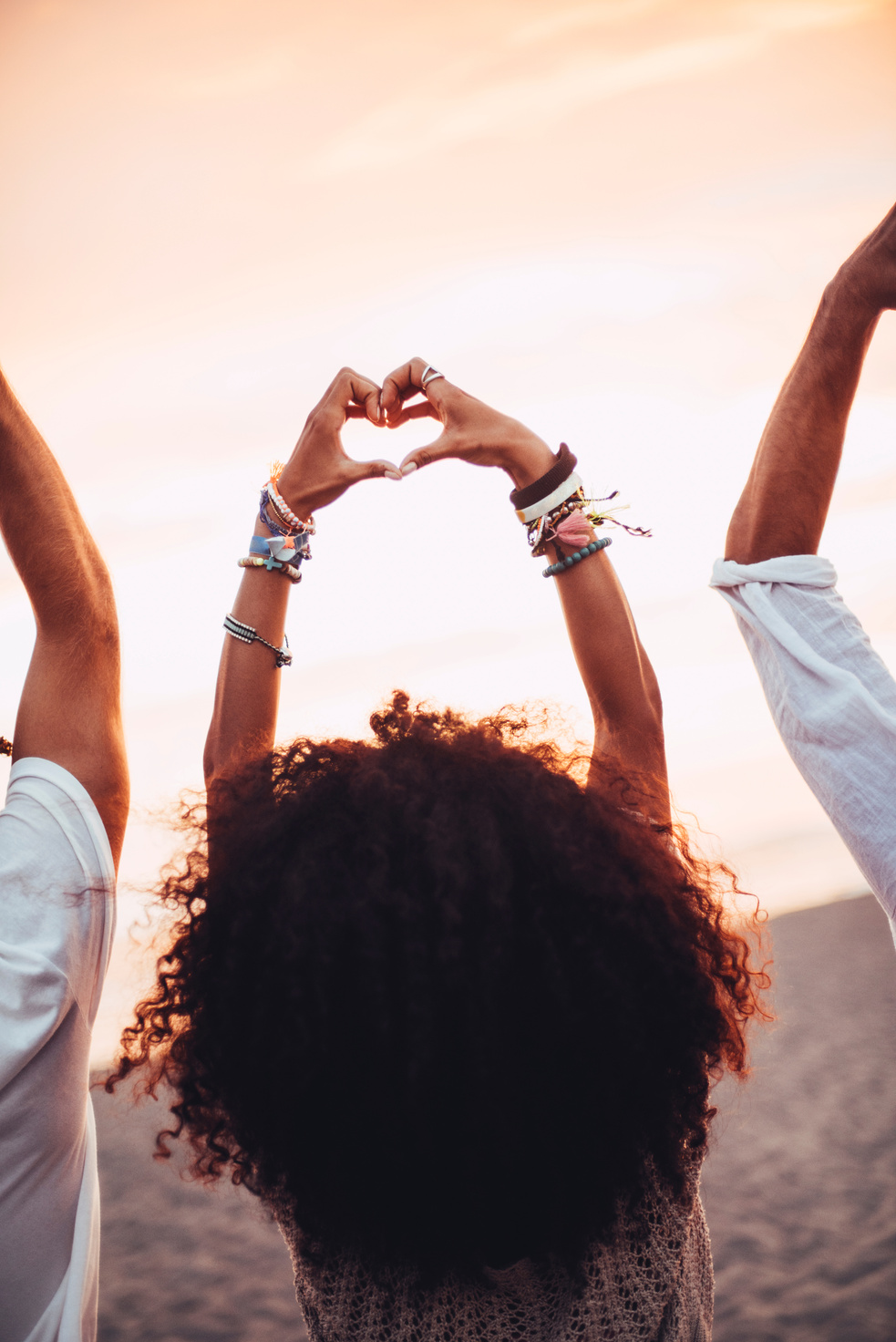 Curly hair girl showing heart